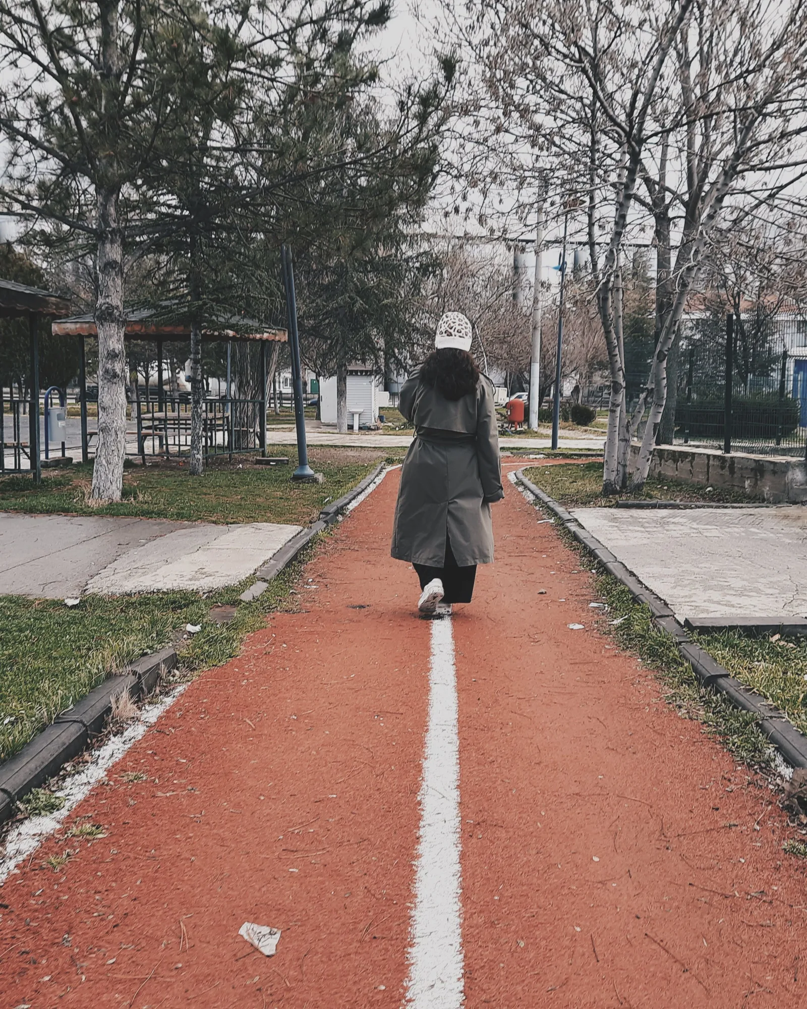 Une femme marche d’un bon pas sur une allée de parc